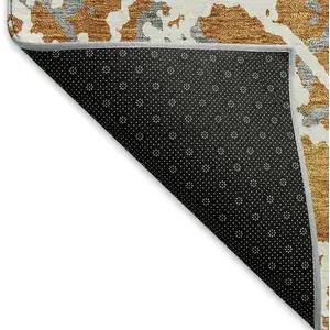 Photo of Copper Gray And Ivory Abstract Washable Area Rug With UV Protection
