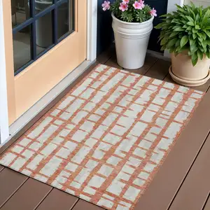 Photo of Coral And Gray Striped Washable Indoor Outdoor Area Rug