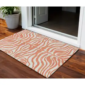 Photo of Coral And Ivory Animal Print Washable Indoor Outdoor Area Rug