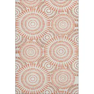 Photo of Coral And Ivory Geometric Washable Area Rug With UV Protection