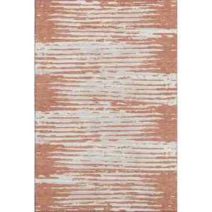 Photo of Coral And Ivory Striped Washable Area Rug With UV Protection