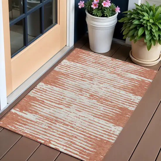 Coral And Ivory Striped Washable Indoor Outdoor Area Rug Photo 1