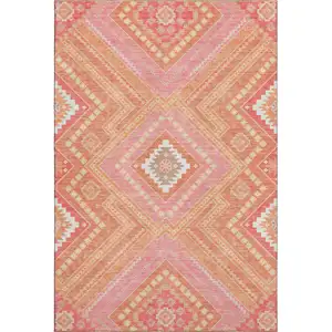 Photo of Coral Pink And Ivory Tribal Washable Area Rug With UV Protection