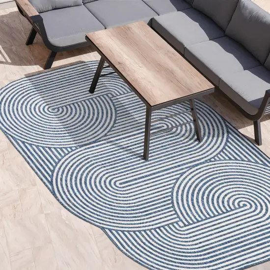 Cream And Navy Blue Abstract Indoor Outdoor Area Rug Photo 9