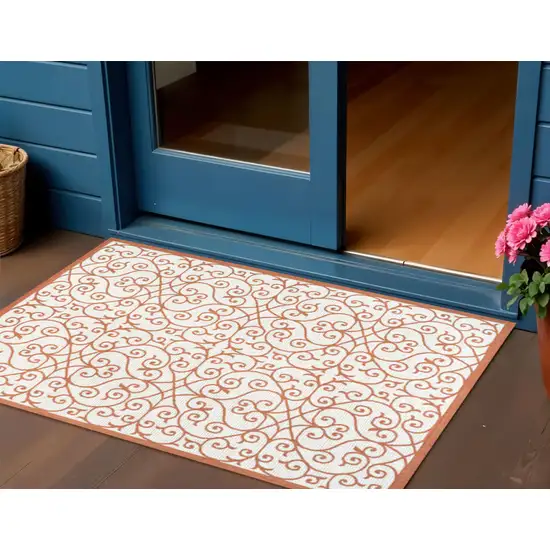 Cream And Orange Geometric Indoor Outdoor Area Rug Photo 1