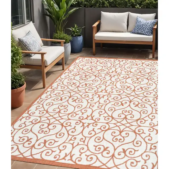 Cream And Orange Geometric Indoor Outdoor Area Rug Photo 1