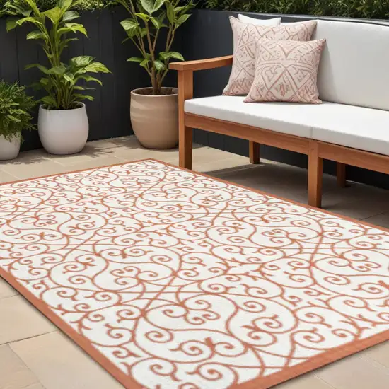 Cream And Orange Geometric Indoor Outdoor Area Rug Photo 1
