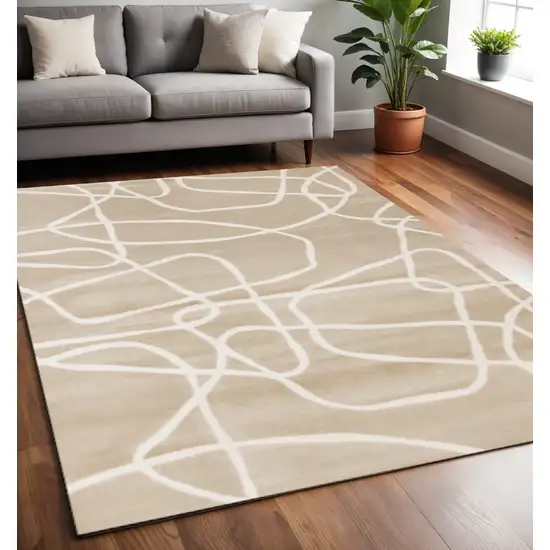 Cream And Tan Abstract Area Rug Photo 1