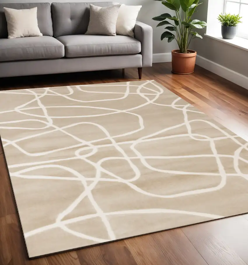 Cream And Tan Abstract Area Rug Photo 1