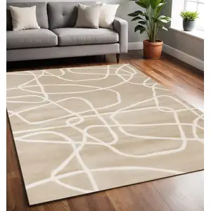 Photo of Cream And Tan Abstract Area Rug