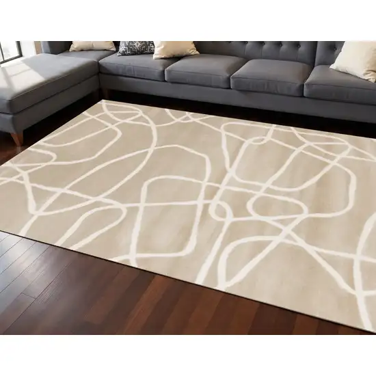 Cream And Tan Abstract Area Rug Photo 1