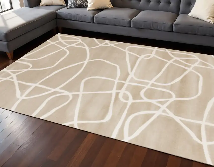 Cream And Tan Abstract Area Rug Photo 1