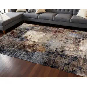 Photo of Cream Black And Tan Abstract Area Rug