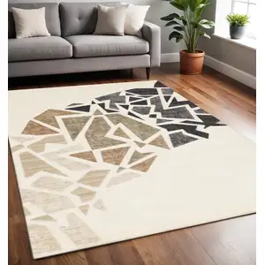 Photo of Cream Black And Tan Abstract Area Rug