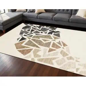 Photo of Cream Black And Tan Abstract Area Rug