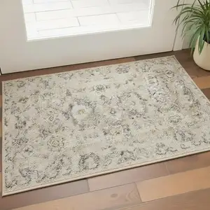 Photo of Cream Black And Yellow Floral Distressed Area Rug