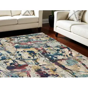 Photo of Cream Blue and Green Abstract Distressed Area Rug