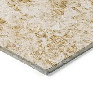 Photo of Cream and Gold Abstract Washable Non Skid Indoor Outdoor Area Rug