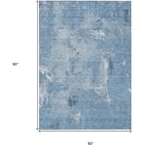 Photo of Denim Blue And Ivory Abstract Washable Indoor Outdoor Area Rug