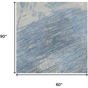 Photo of Denim Blue Ivory And Beige Abstract Washable Area Rug With UV Protection