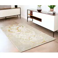 Photo of Gold Abstract Area Rug With Fringe