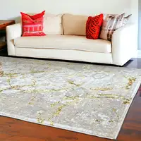 Photo of Gold Abstract Area Rug With Fringe