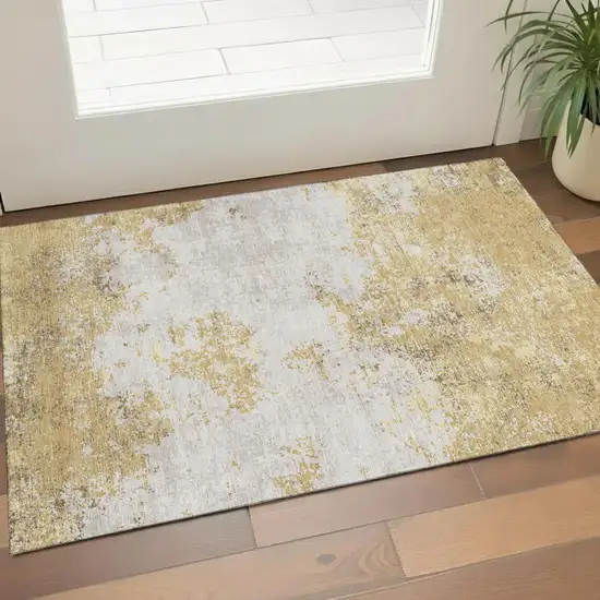 Gold And Beige Abstract Washable Area Rug With UV Protection Photo 1