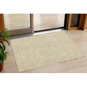 Photo of Gold And Beige Abstract Washable Indoor Outdoor Area Rug