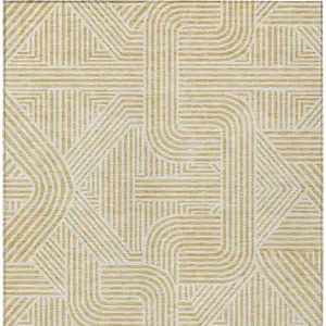Photo of Gold And Beige Abstract Washable Indoor Outdoor Area Rug