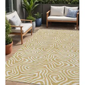 Photo of Gold And Beige Abstract Washable Indoor Outdoor Area Rug