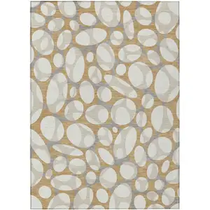Photo of Gold And Beige Abstract Washable Indoor Outdoor Area Rug
