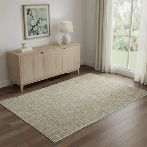 Photo of Gold And Ivory Abstract Geometric Distressed Washable Area Rug