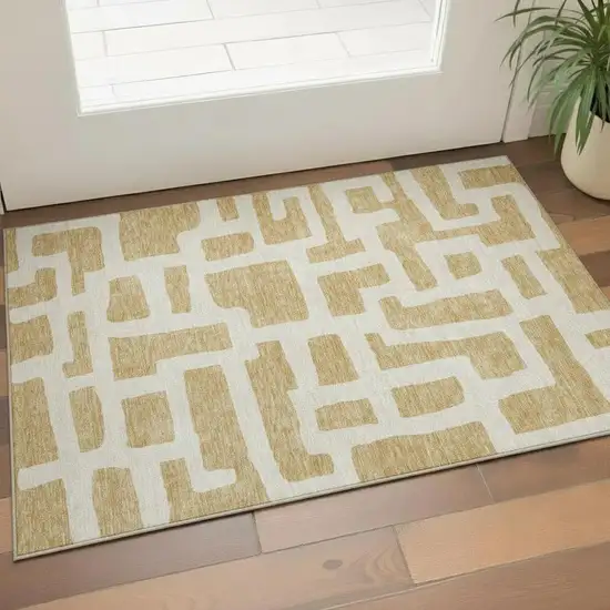 Gold And Ivory Abstract Geometric Washable Area Rug With UV Protection Photo 1