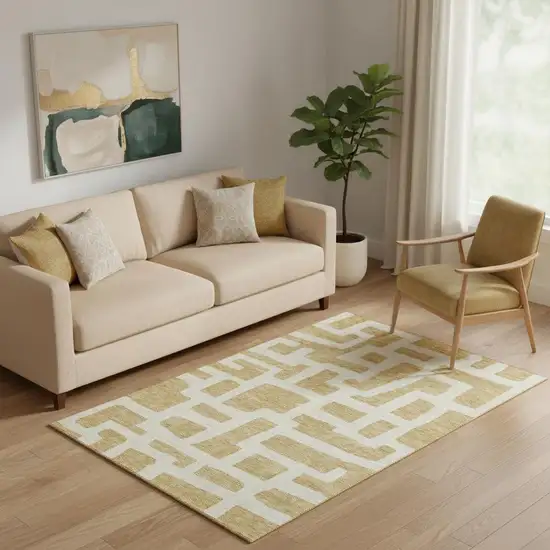 Gold And Ivory Abstract Geometric Washable Area Rug With UV Protection Photo 1
