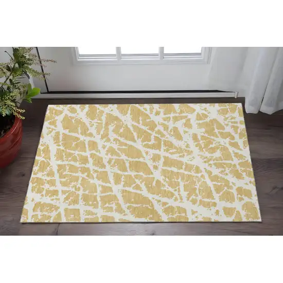 Gold And Ivory Abstract Washable Area Rug With UV Protection Photo 2