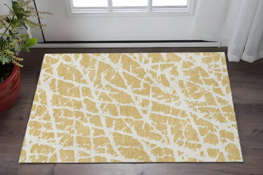 Gold And Ivory Abstract Washable Area Rug With UV Protection Photo 2