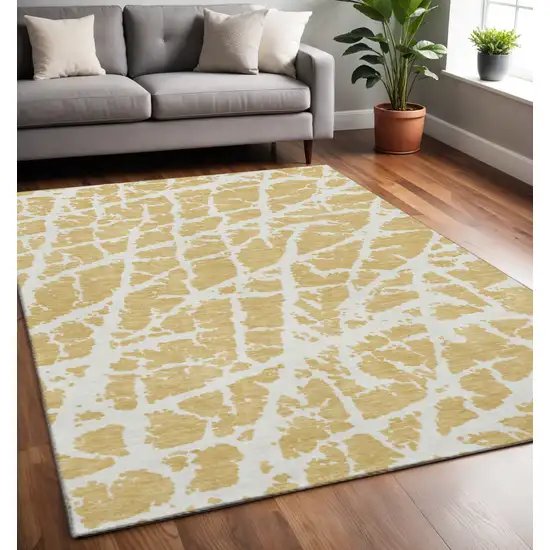 Gold And Ivory Abstract Washable Area Rug With UV Protection Photo 2