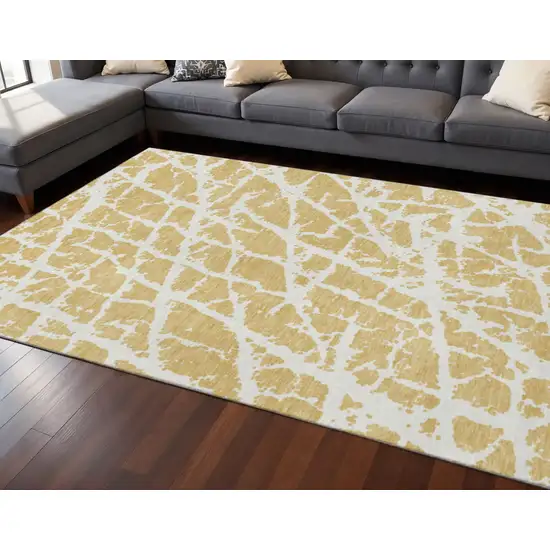 Gold And Ivory Abstract Washable Area Rug With UV Protection Photo 2