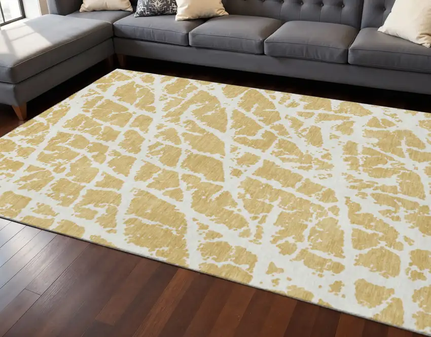 Gold And Ivory Abstract Washable Area Rug With UV Protection Photo 2
