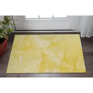 Photo of Gold And Ivory Abstract Washable Area Rug With UV Protection