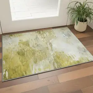 Photo of Gold And Ivory Abstract Washable Area Rug With UV Protection