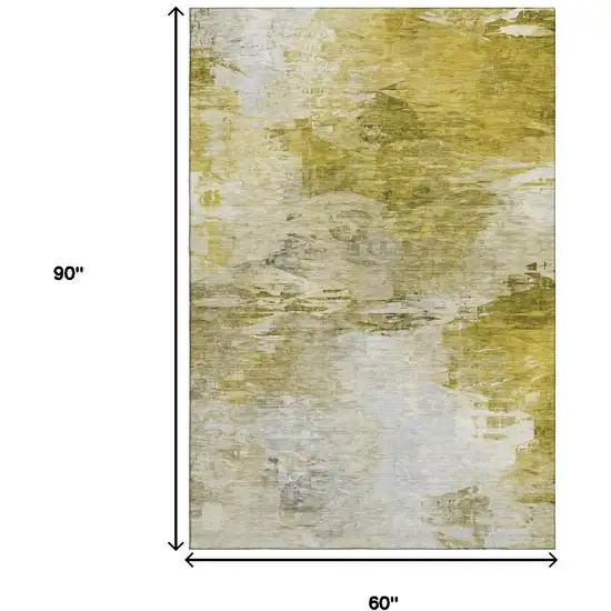 Gold And Ivory Abstract Washable Area Rug With UV Protection Photo 3