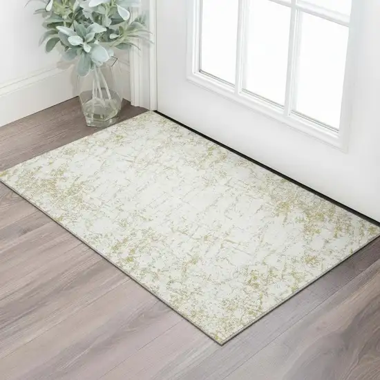 Gold And Ivory Abstract Washable Area Rug With UV Protection Photo 1