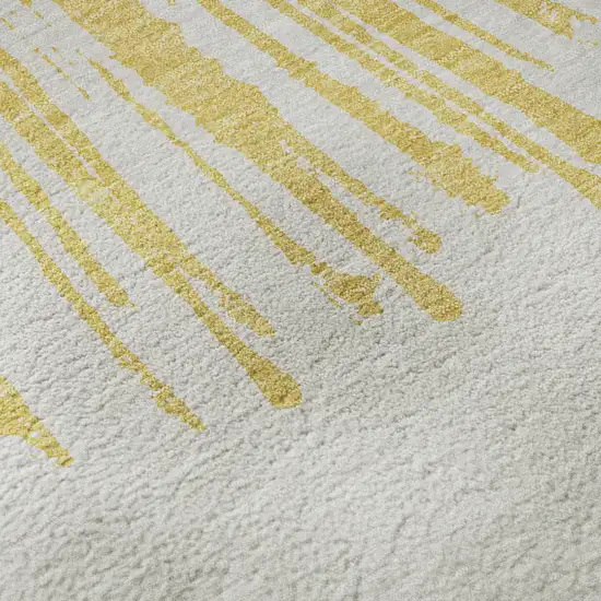 Gold And Ivory Abstract Washable Area Rug With UV Protection Photo 3