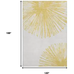 Photo of Gold And Ivory Abstract Washable Area Rug With UV Protection