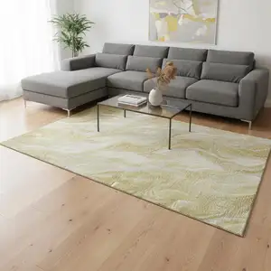 Photo of Gold And Ivory Abstract Washable Area Rug With UV Protection