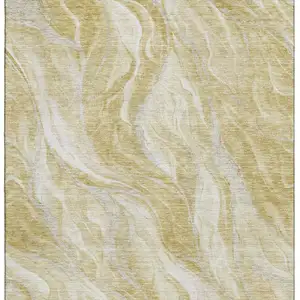 Photo of Gold And Ivory Abstract Washable Area Rug With UV Protection