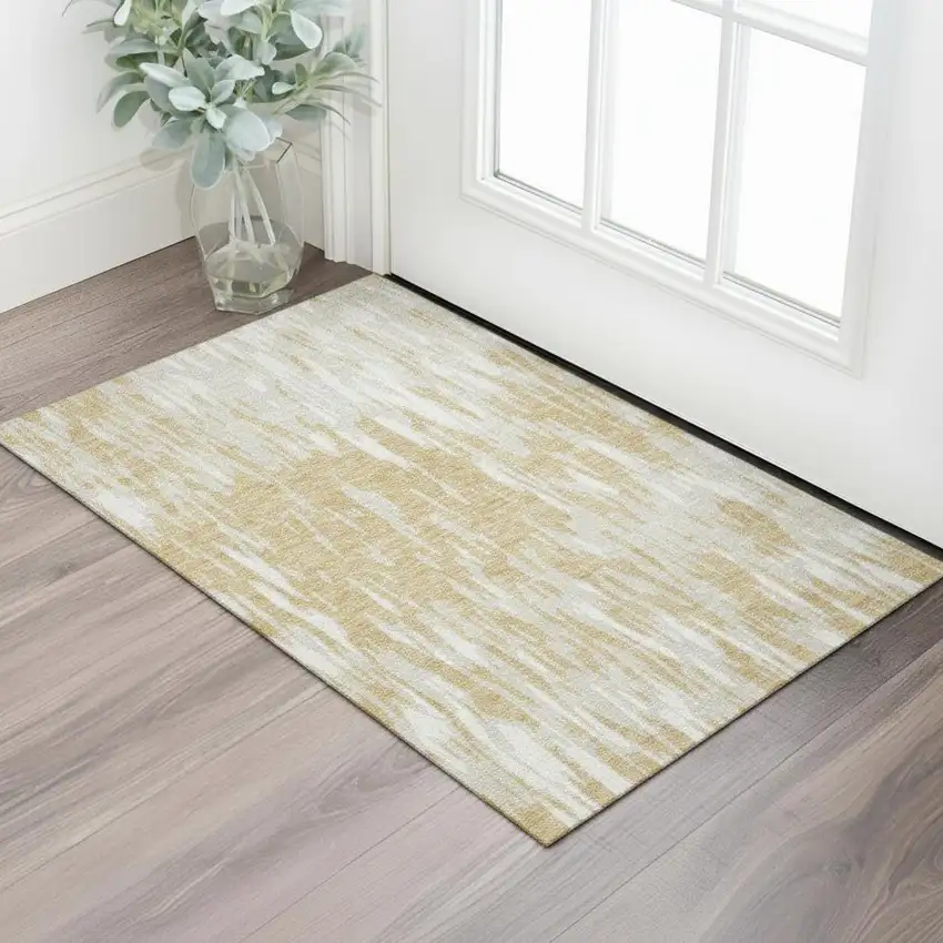 Gold And Ivory Abstract Washable Area Rug With UV Protection Photo 1