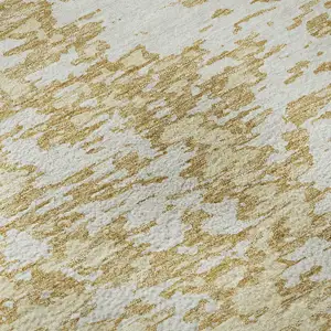 Photo of Gold And Ivory Abstract Washable Area Rug With UV Protection