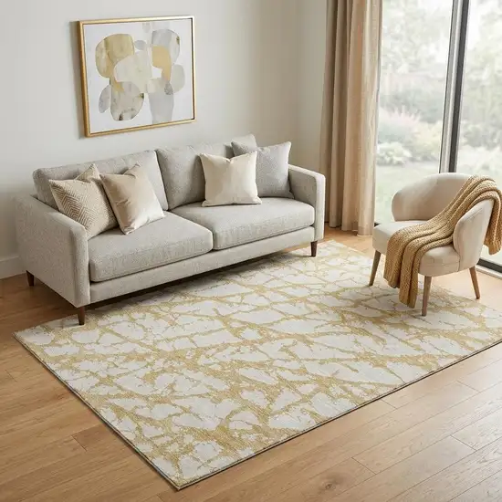 Gold And Ivory Abstract Washable Area Rug With UV Protection Photo 1